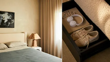 a cream bed frame with blue sheets and a storage compartment under the bed to store shoes, books and linens