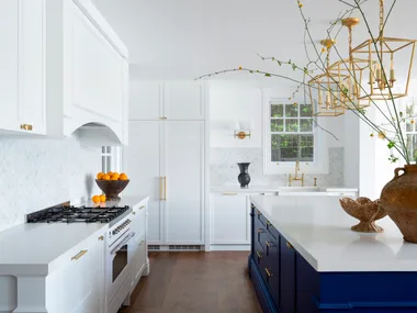 A classic Hamptons kitchen with a bold blue island