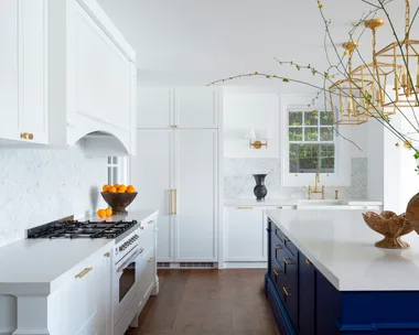 A classic Hamptons kitchen with a bold blue island