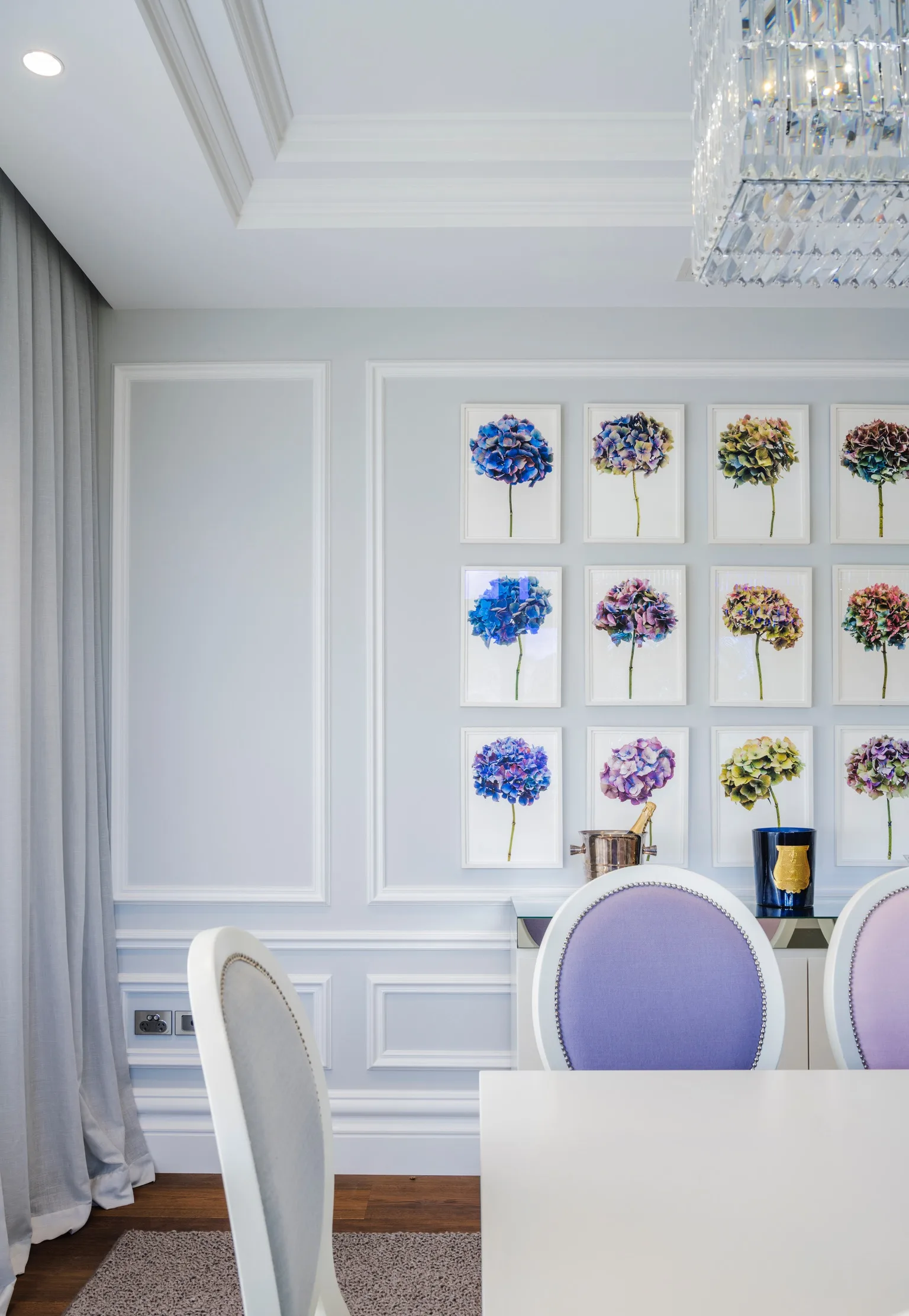 Nicole Gazal O’Neil’s home features a formal dining room with wainscoting, pastel chairs and Rachel Levy’s hydrangea photographs.