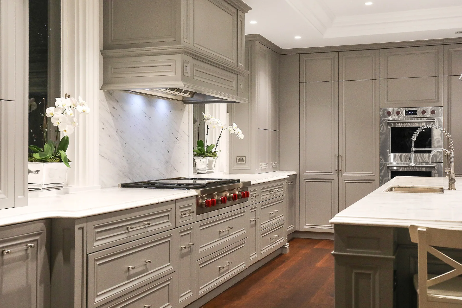 Nicole Gazal O’Neil’s Sydney home features a grey Hamptons-style marble kitchen with an island bench, detailed joinery, stovetop, double ovens and rangehood.