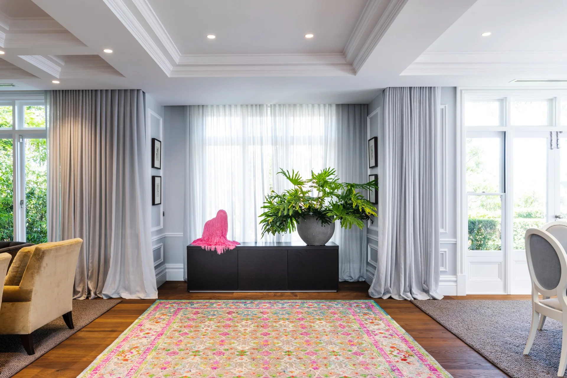 Nicole Gazal O’Neil’s home features a pink oriental rug complemented by a Troy Emery silky drape dog sculpture.