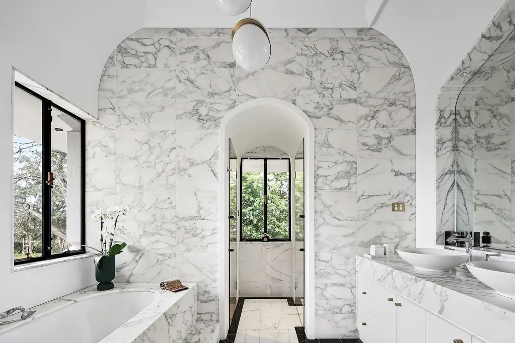 White and marble tiles bathroom in a Walter Burley Griffin house in Pymble.