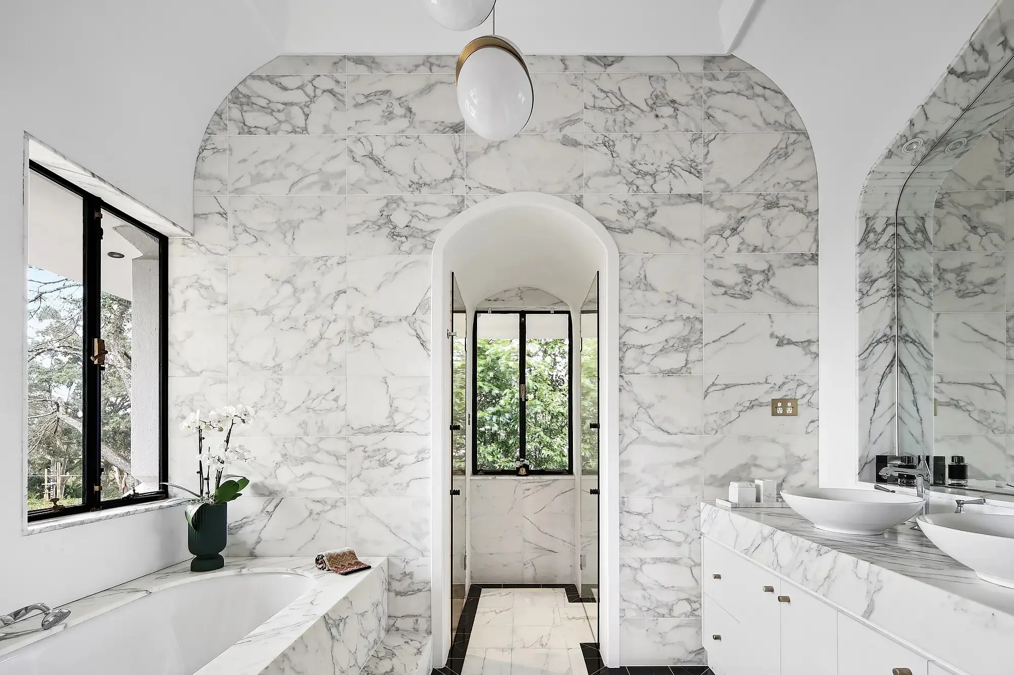 White and marble tiles bathroom in a Walter Burley Griffin house in Pymble.