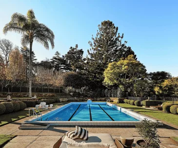 Swimming pool and Paul Bangay-designed gardens at a Walter Burley Griffin house in Pymble.