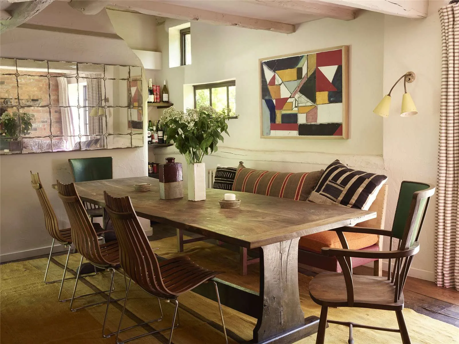 Sienna Miller's English cottage formal dining room with a large timber table