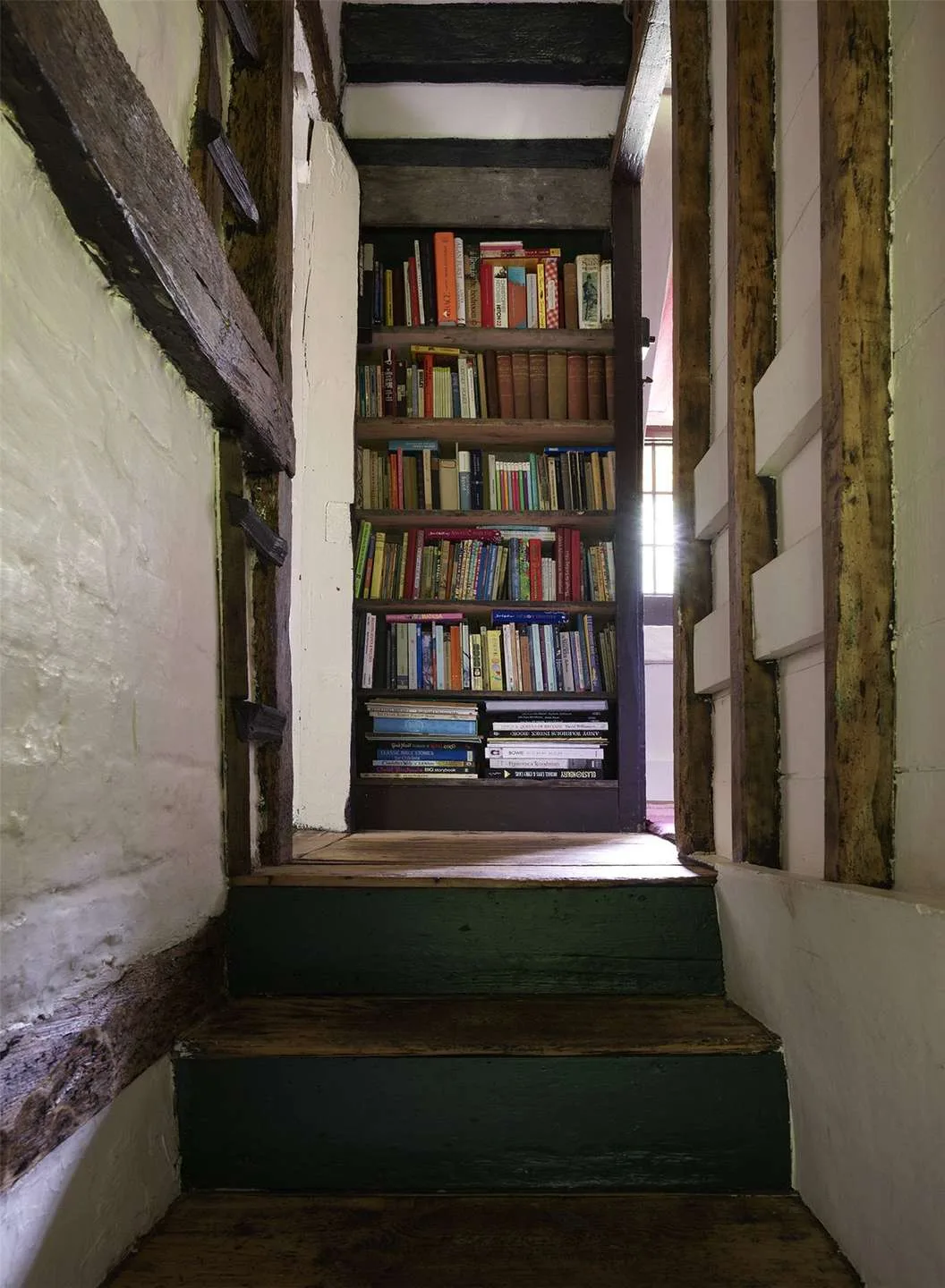 the stairs in Sienna Miller's cottage leading to a bookshelf