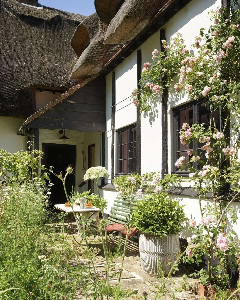 Sienna Miller's english cottage door and patio beset by a wildflower garden