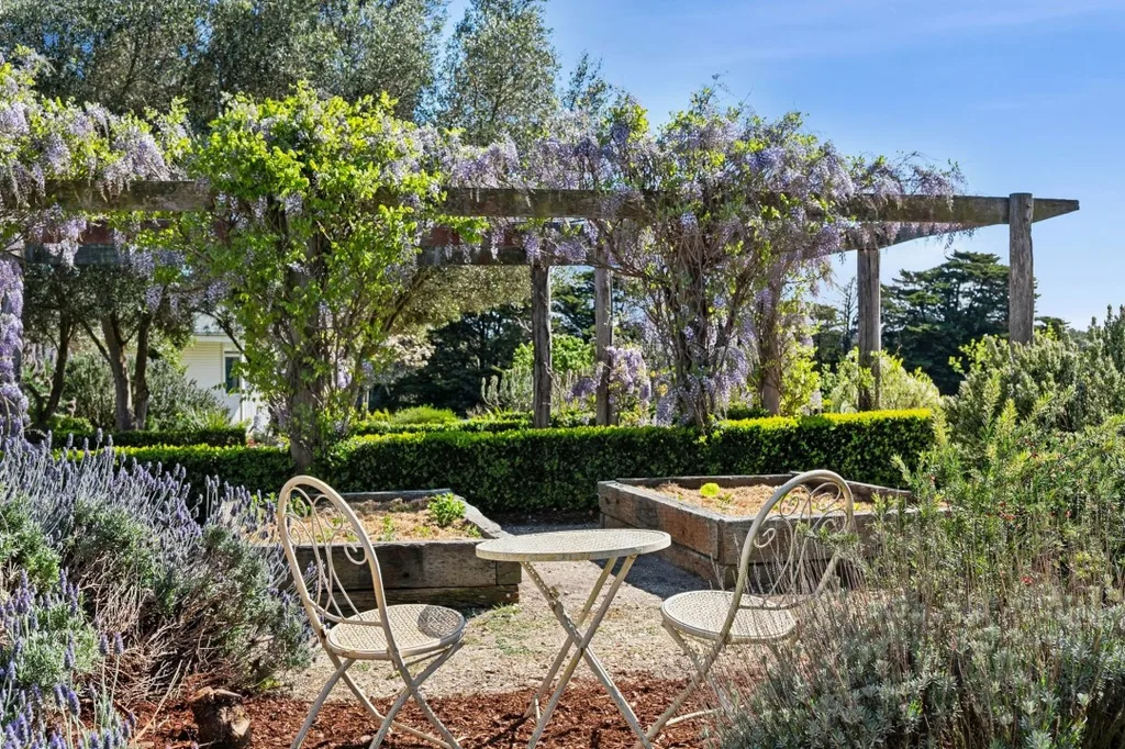 Wisteria arbor and outdoor tables and chairs at Tom and Emma Hawkins' Barrabool farmhouse.