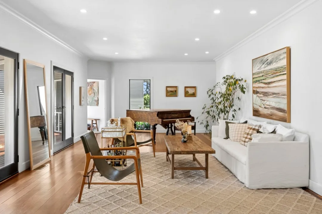 Living room featuring a grand piano in Tom and Emma Hawkins' farmhouse living room.