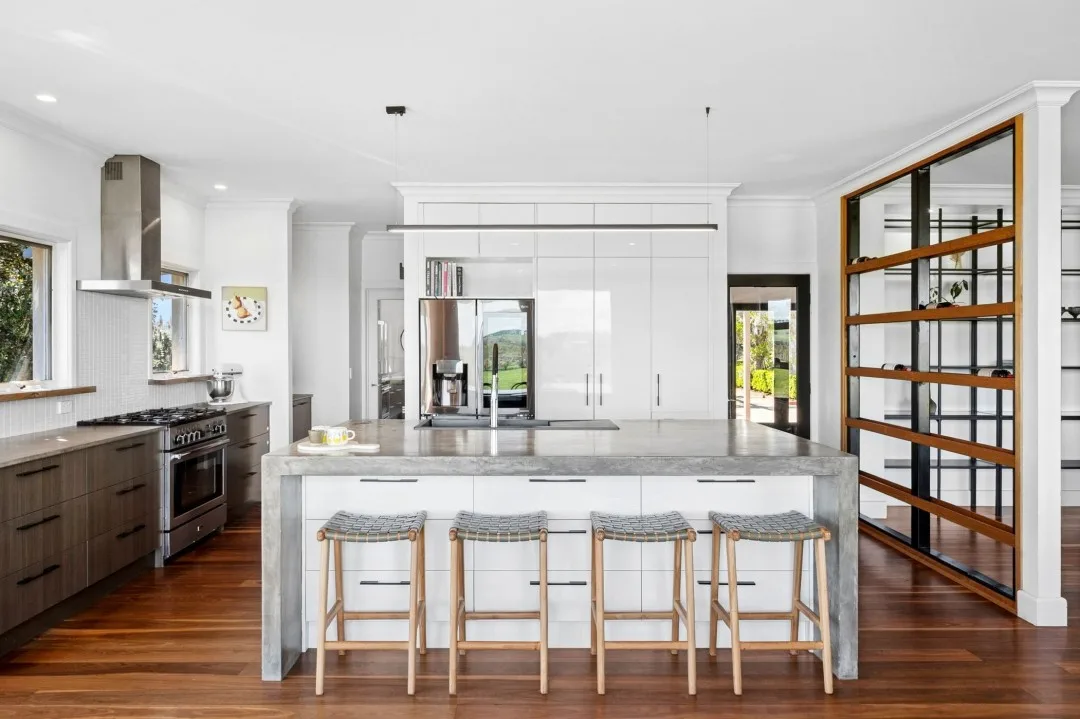 White and concrete-look kitchen in Tom and Emma Hawkins' country house kitchen.