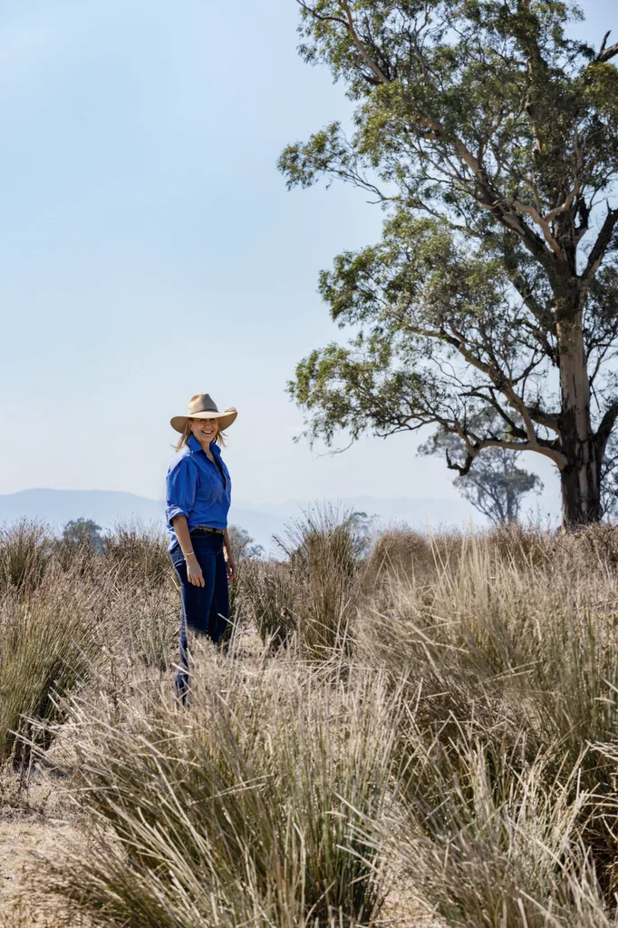 Adelaide Bragg stands in the bush.