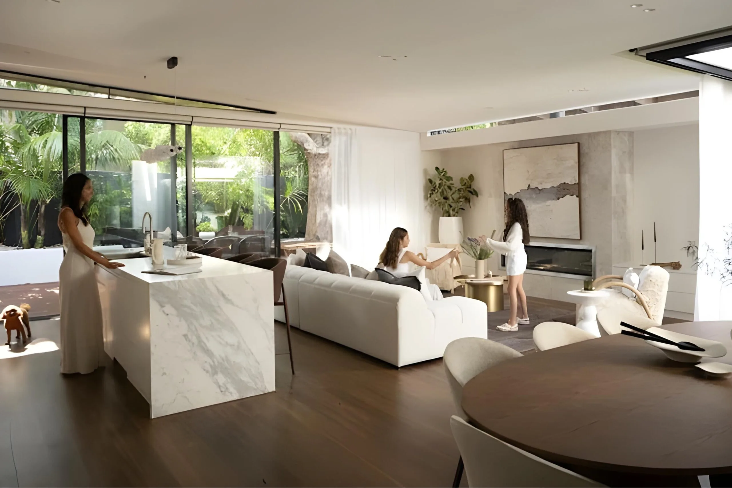 Unitex director Afsoon Kisirwani with her daughters and cavoodle dog in the kitchen and living room of their Sydney home.