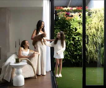 Unitex director Afsoon Kisirwani with her daughters and cavoodle dog in their Sydney home.