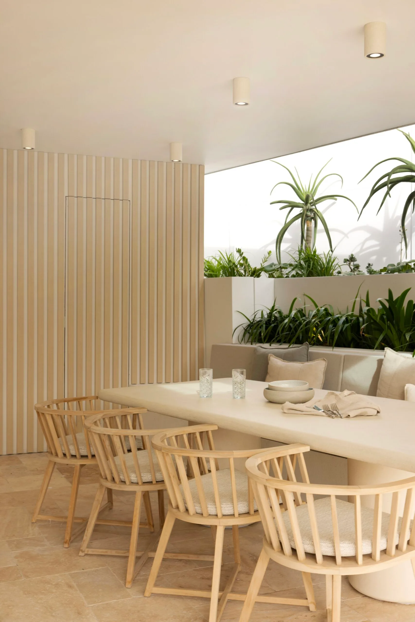 Alfresco outdoor entertaining zone at a coastal Sydney house with a neutral, beige Mediterranean aesthetic.