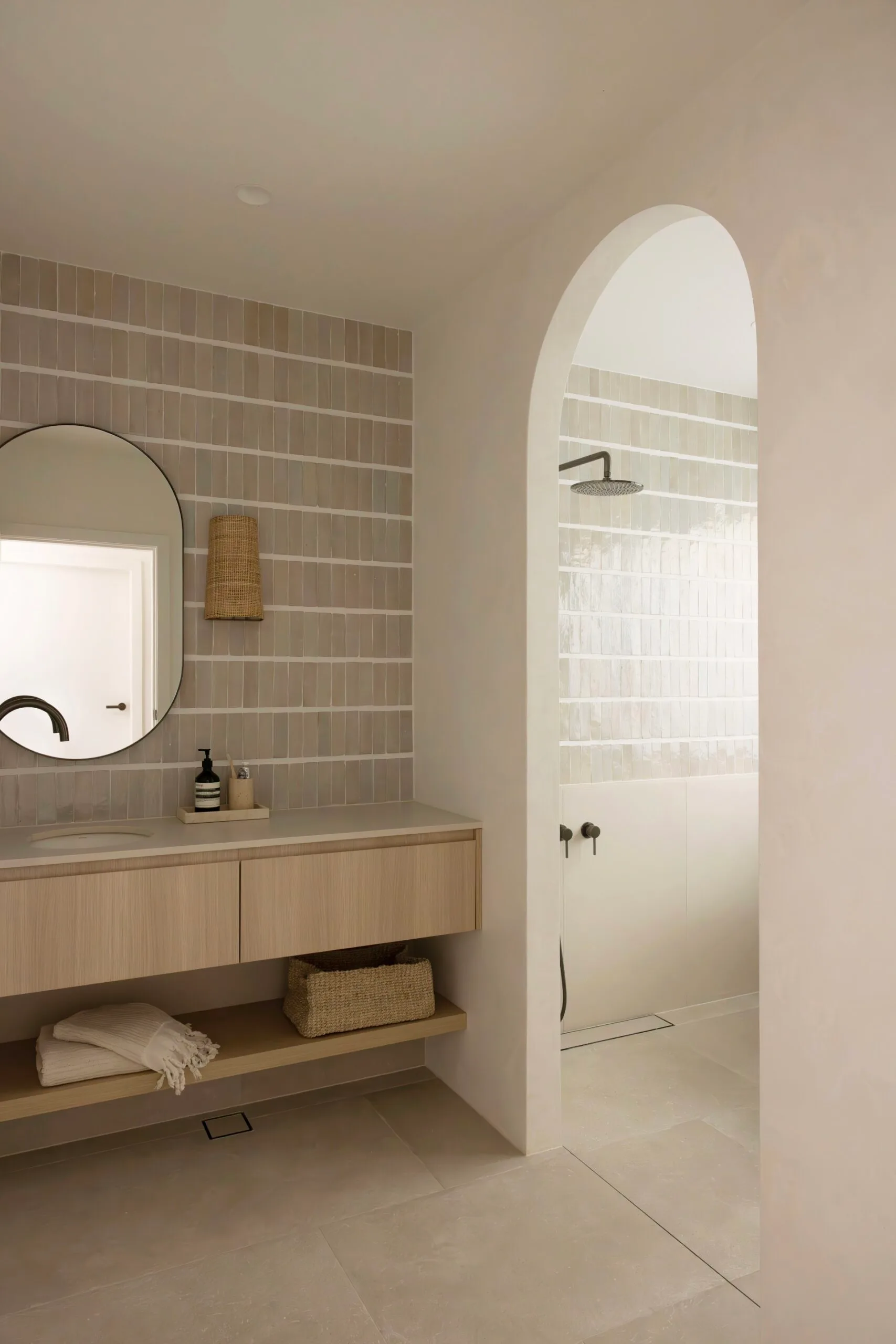 Main bathroom in a coastal Sydney house with a neutral, beige Mediterranean aesthetic featuring bejmat wall tiles.