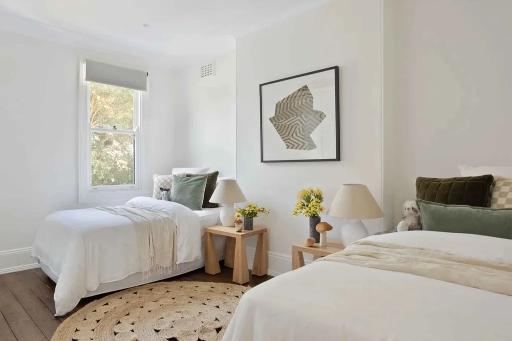 Kids' bedroom in a Sydney Victorian-era terrace-style house with two beds decorated with an earthy palette.