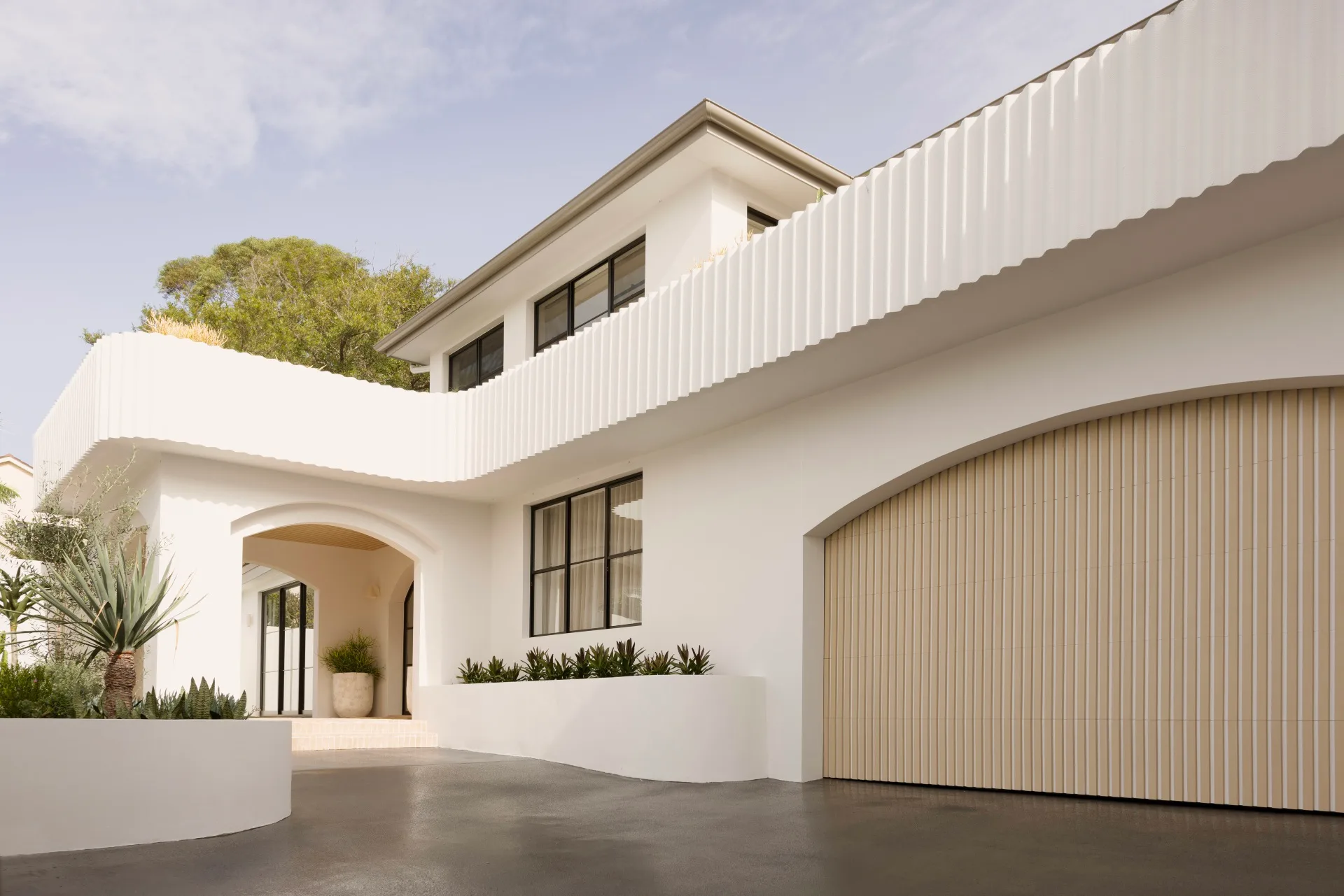 Exterior of a large white Mediterranean house on the coast of Sydney