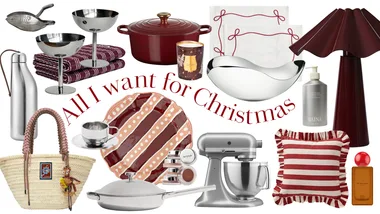 Home Beautiful's Christmas gift guide hero image. The text says 'All I want for Christmas' and is surrounded by products that are largely red, stainless steel or neutral in tone. These include pans, stand mixers, cookware, candles, tableware, and lamps.