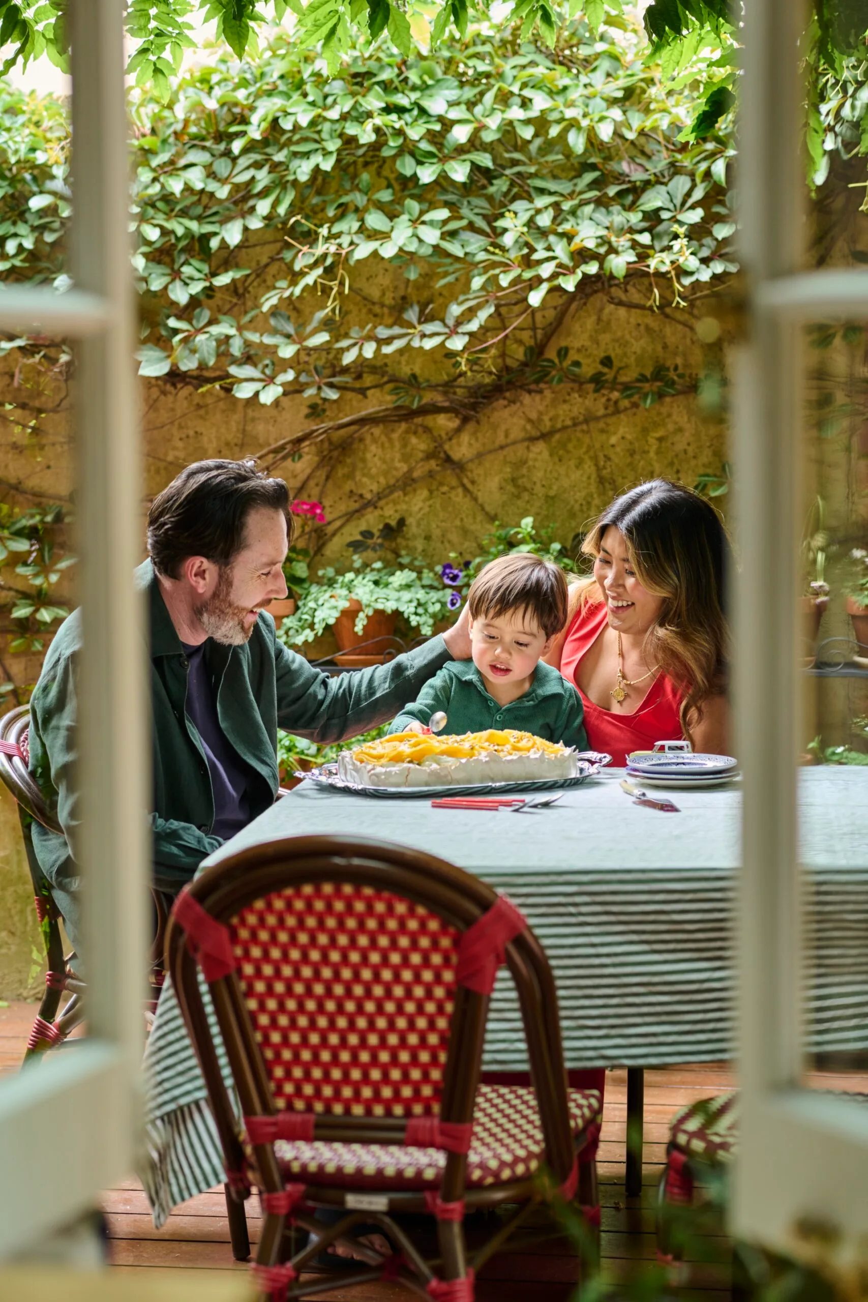 Jess Ngyuyen with her husband and son in their courtyard. 