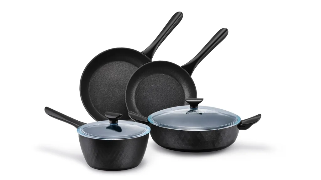 A four piece cookware set, including two open French skillets, a saucepan and a Sauteuse. These last two items have glass lids.