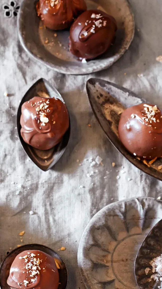 almond chocolate truffles displayed in vintage silver dishes on a linen tablecloth