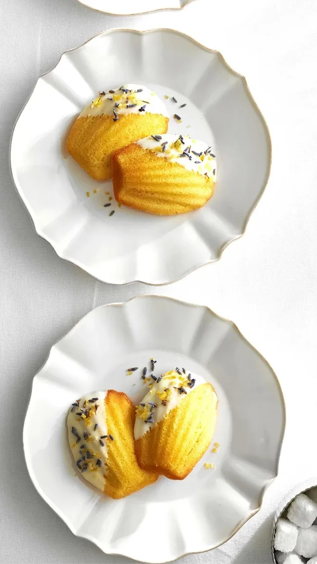 two lemon madeleines for Valentine's Day on two white plates