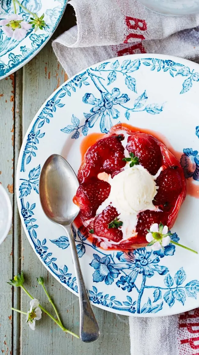 strawberry tarte tartin for valentine's day on a blue china plate with silver spoon