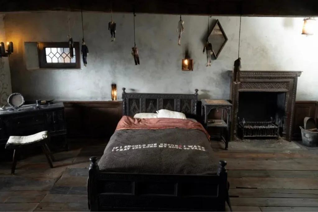 Wuthering Heights Catherine childhood bedroom hanging dolls and words on bedspread