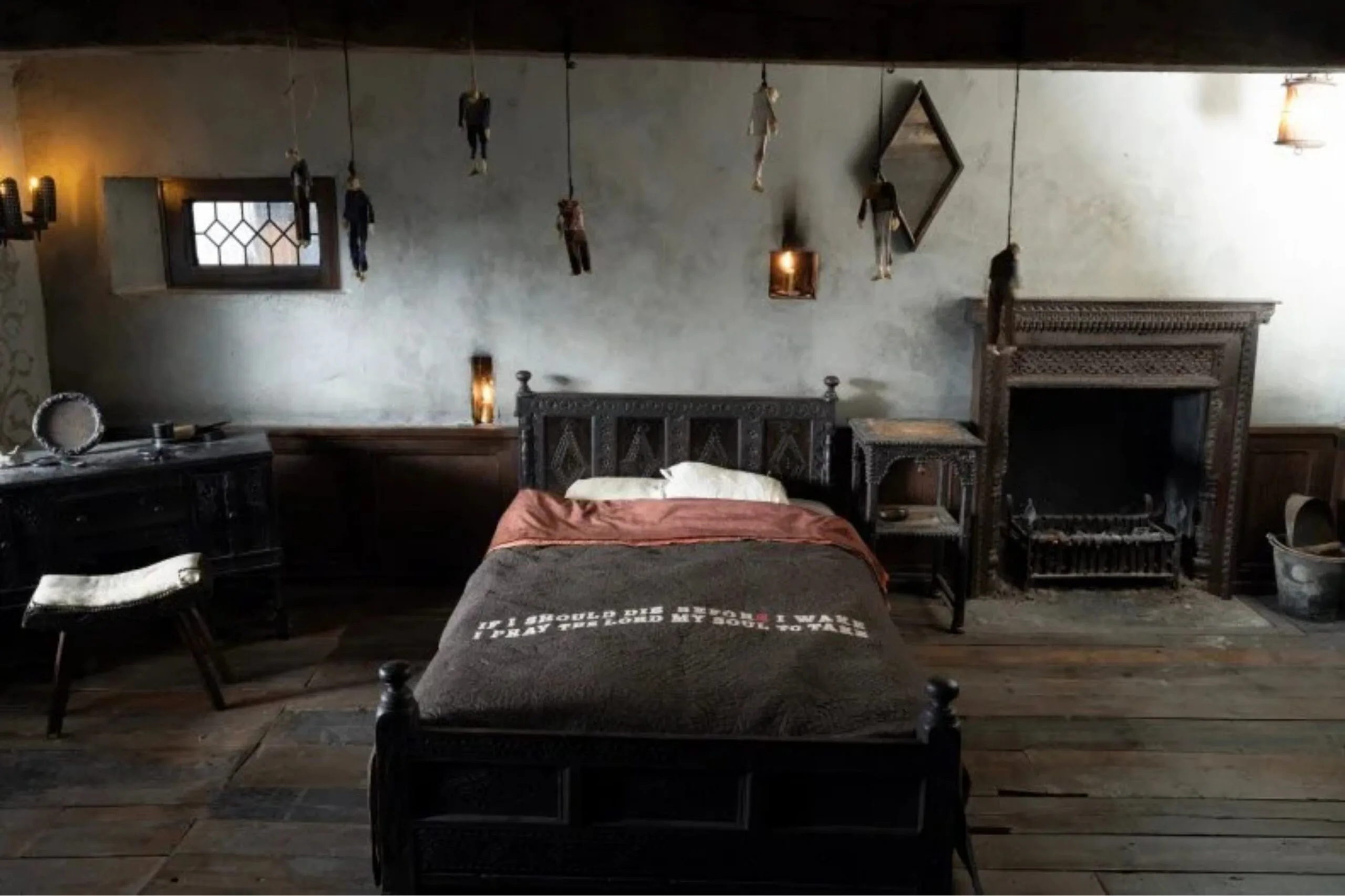 Wuthering Heights Catherine childhood bedroom hanging dolls and words on bedspread