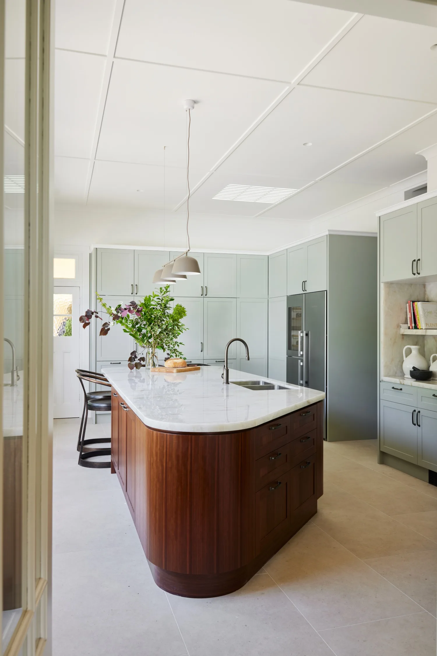 Blue Mountains home green kitchen curved timber veneer island