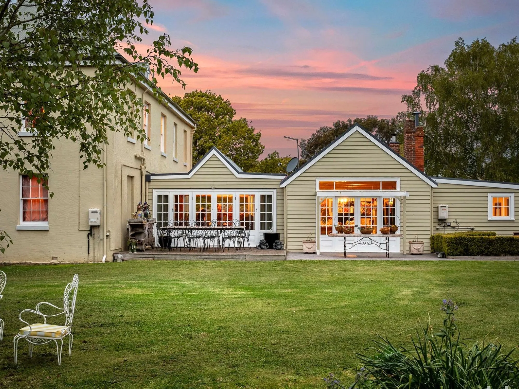 Picturesque paved patio and lawn for the back exterior of historic Cleveland House in Tasmania