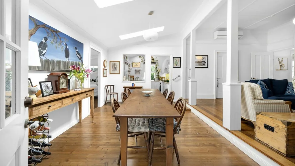 Dining room with long timber dining table and hardwood floors