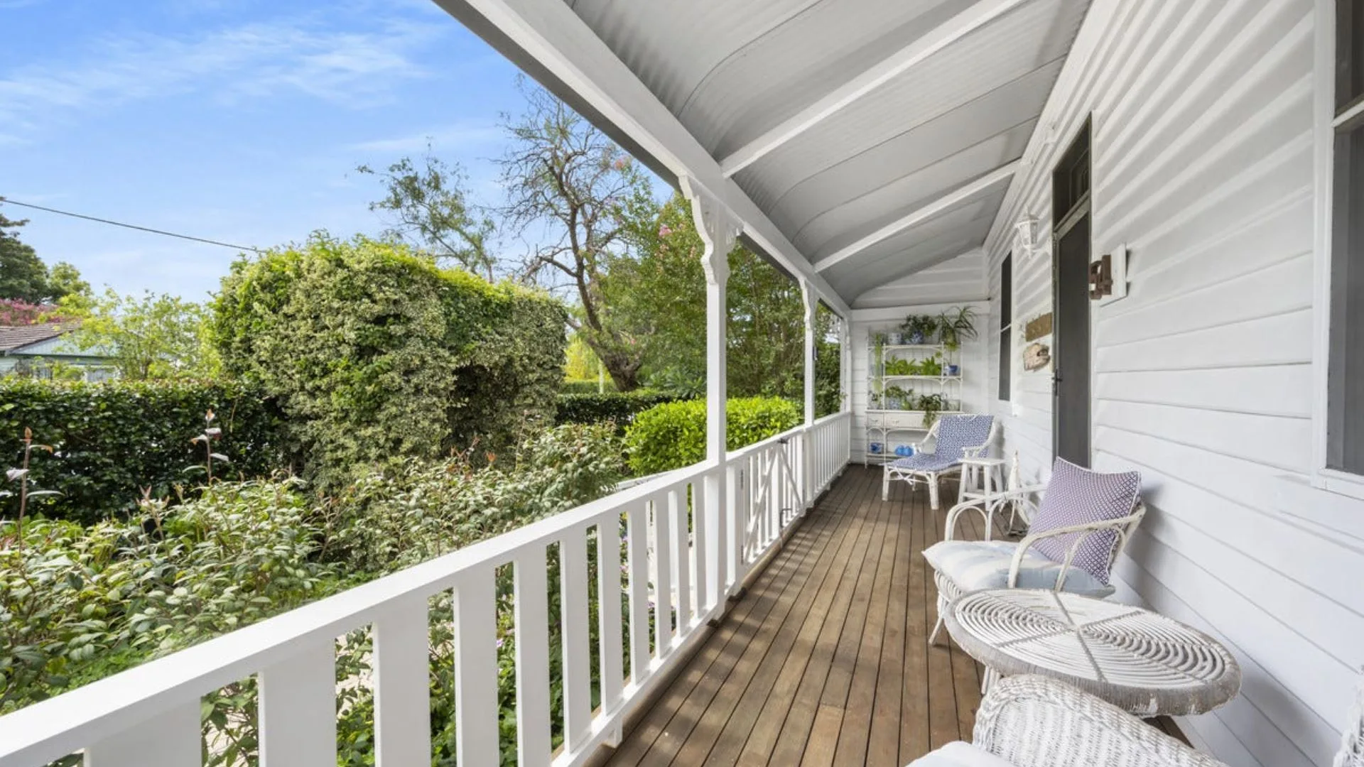A long timber verandah on Neale Whitaker's white weatherboard cottage