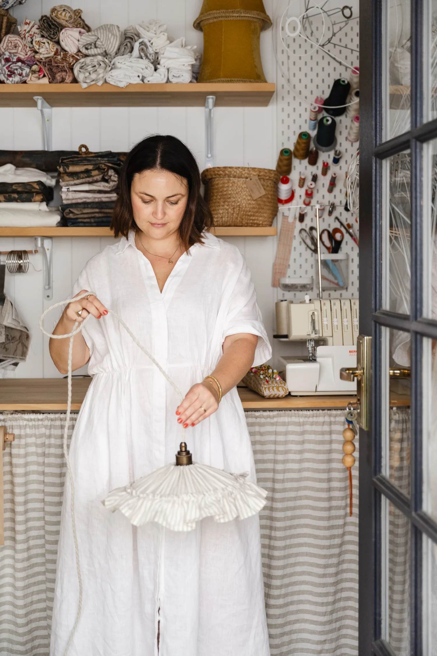 Ramble Interiors creator Alicia Doyle holding a ruffled pendant