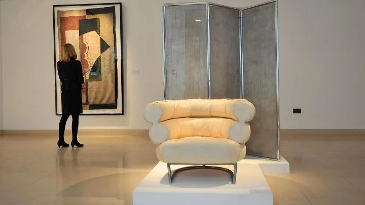 Eileen Grey Bibendum armchair displayed in a museum setting for an auction