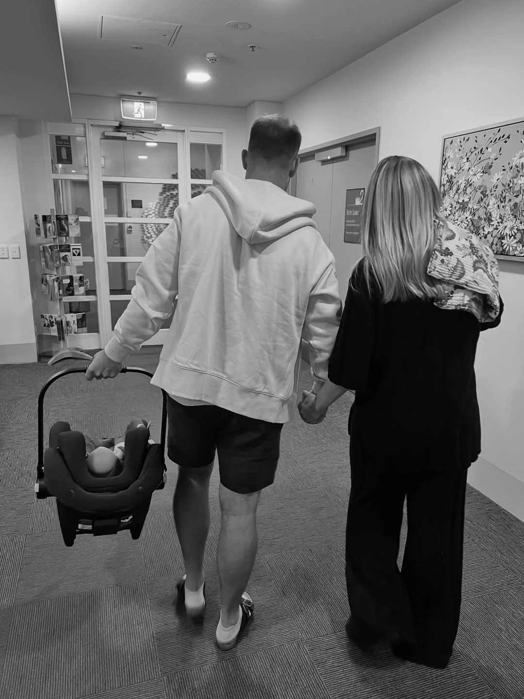 Dan and Dani Reilly with their baby leaving hospital