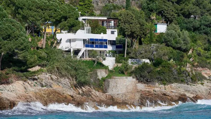 A far away view of Eileen Gray's blue and white E1027 house in Roquebrune Cap Martin 