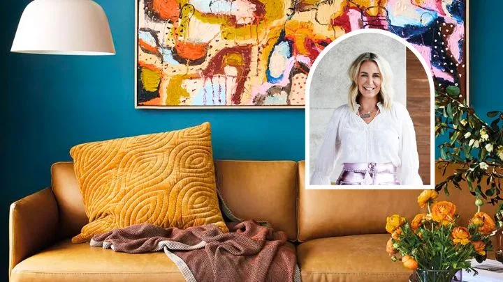 A colourful blue room with a brown leather couch and colourful artwork, with a portrait of Julia Green inset.