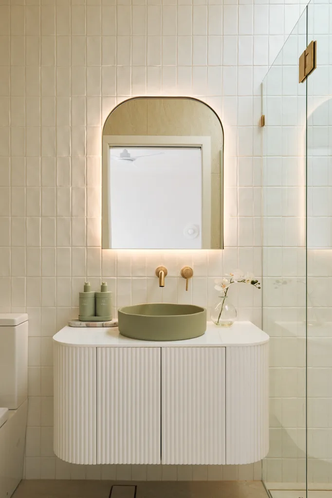 White kitchen with sage green round basin and fold tap details