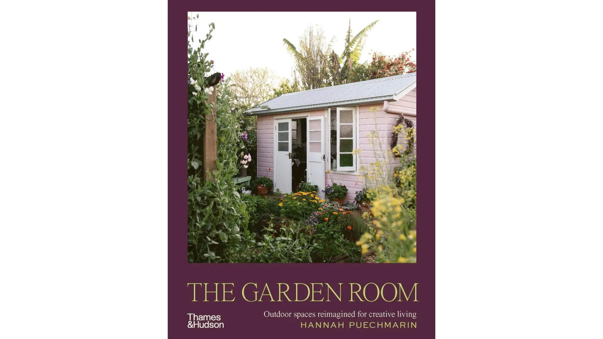A copy of The Garden Room by Hannah Puechmarin. A pink cottage and cottage garden is on the cover.