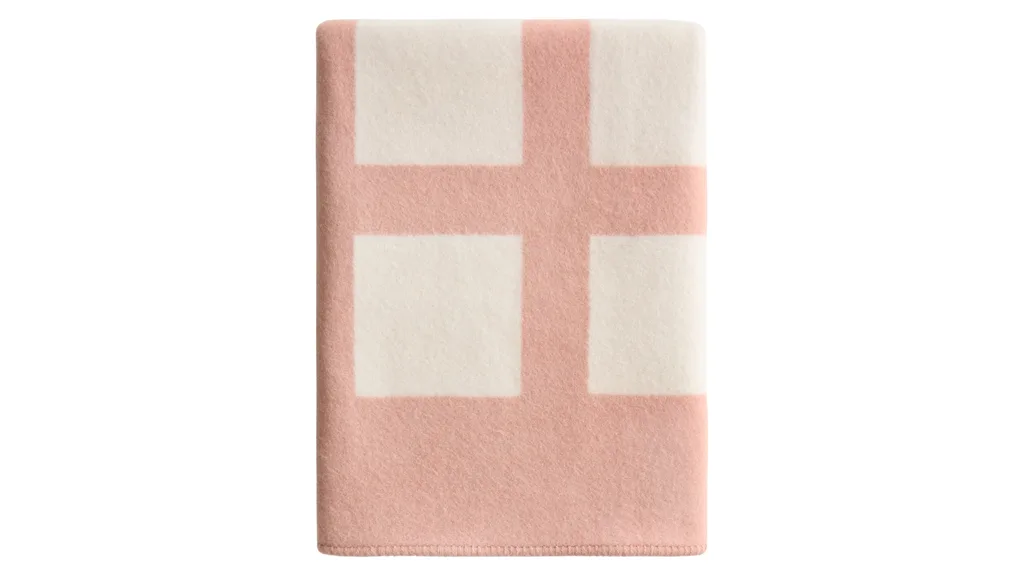 A pink and white throw blanket.