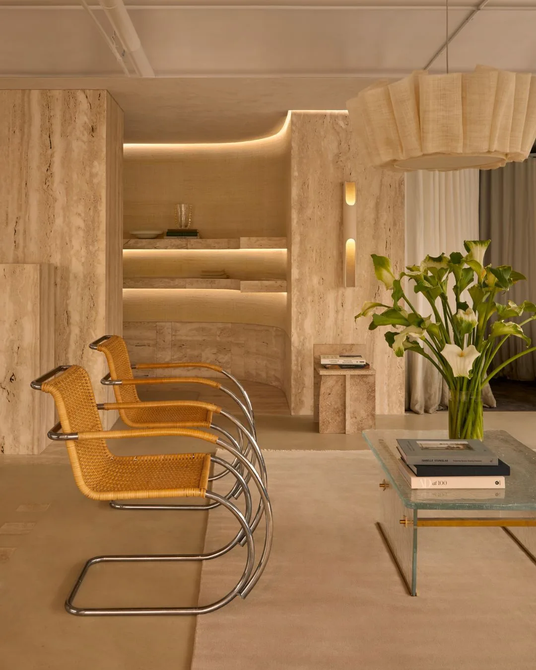 Two cane armchairs with metal accents in a travertine marble store for Dissh Bondi