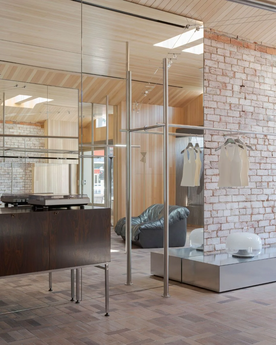 Exposed brick wall and mirrors at the Henne Armadale retail store