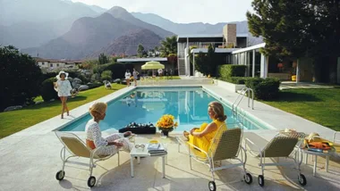 A mid century modern house designed by influential 20th century architect and designer Richard Neutra, as photoraphed by Slim Aarons with two women lounging by the pool