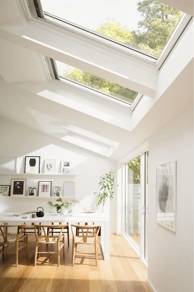 Velux skylight in pitched roof of home over dining and kitchen space