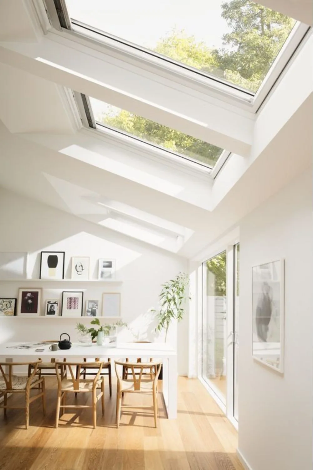 Velux skylight in pitched roof of home over dining and kitchen space