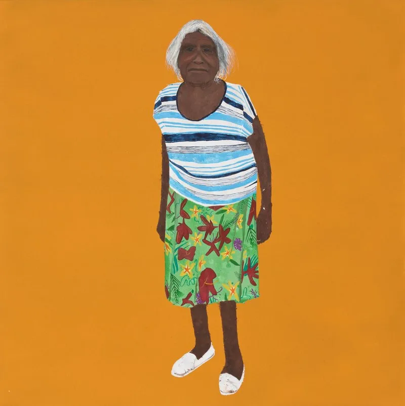 A portrait painting of an Indigenous woman, a Pitjantjatjara Elder, wearing bright coloured clothing standing in front of an orange background. The medium is synthetic polymer paint on canvas.
