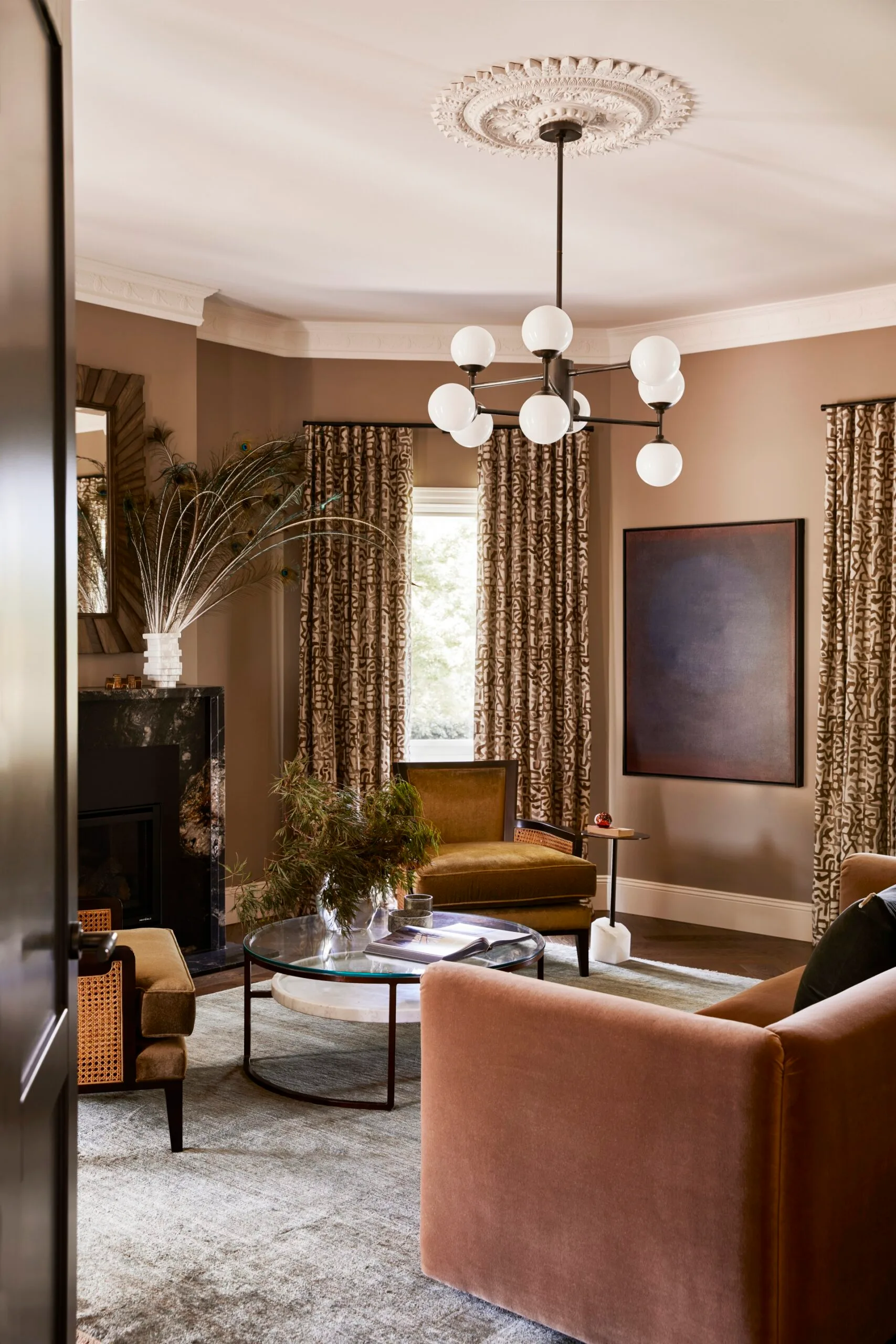 living room with dusty pink walls and velvet armchairs