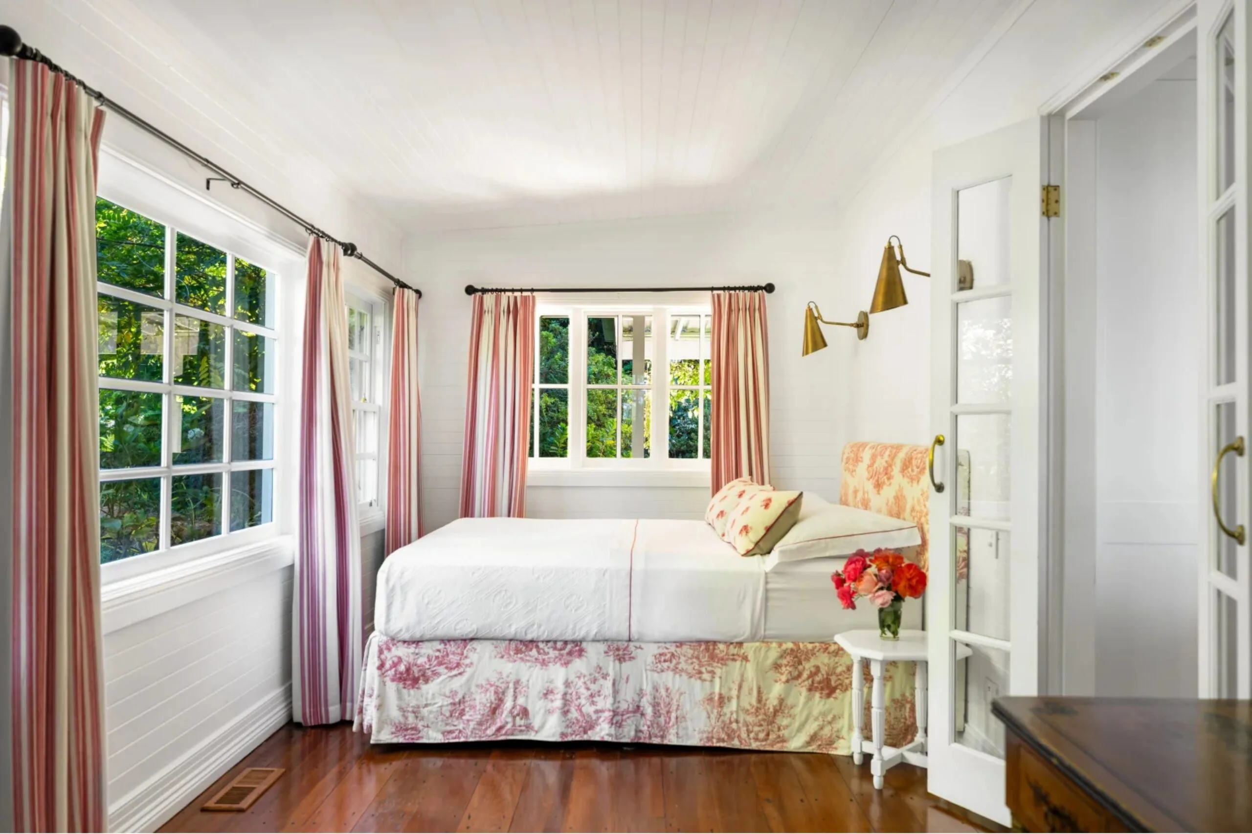 Bedroom with striped curtains and patterned bed skirt
